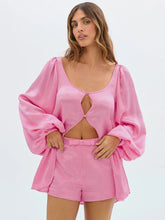 Woman wearing a pink outfit with a top and shorts
